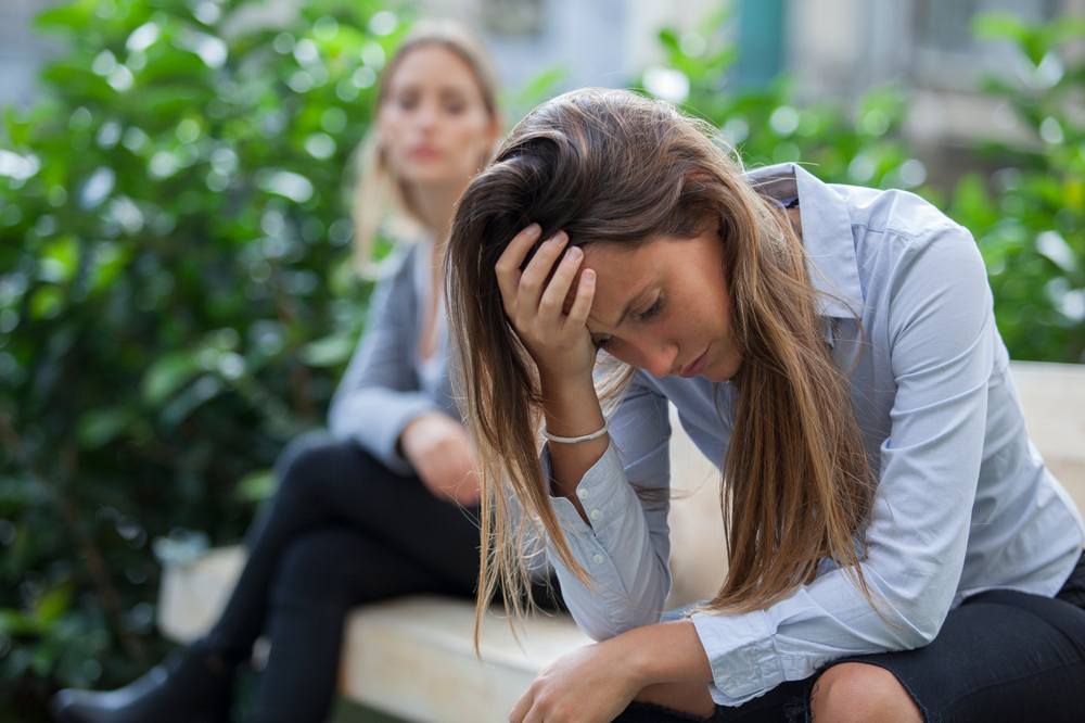 What Trauma Therapy in Ottawa Actually Looks Like—And How to Know If You Need It. Portrait of a young woman and a friend outdoors on the street, having problems. Depression concept.